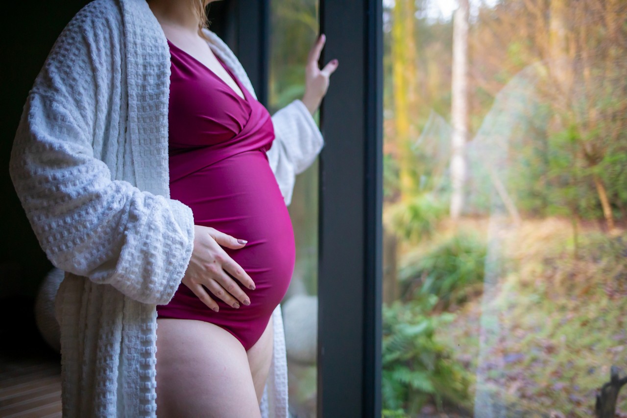 Woman touching her bump.